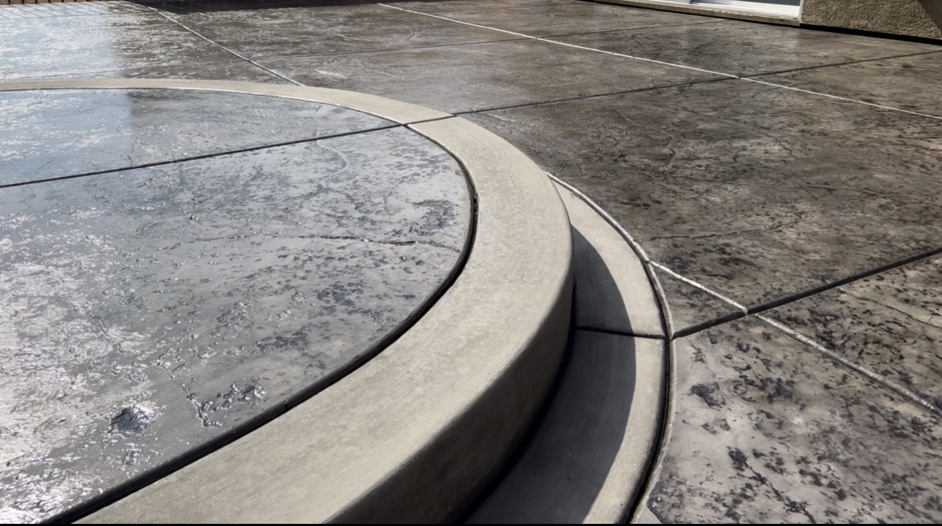 Detail of curved concrete step and decorative concrete surface