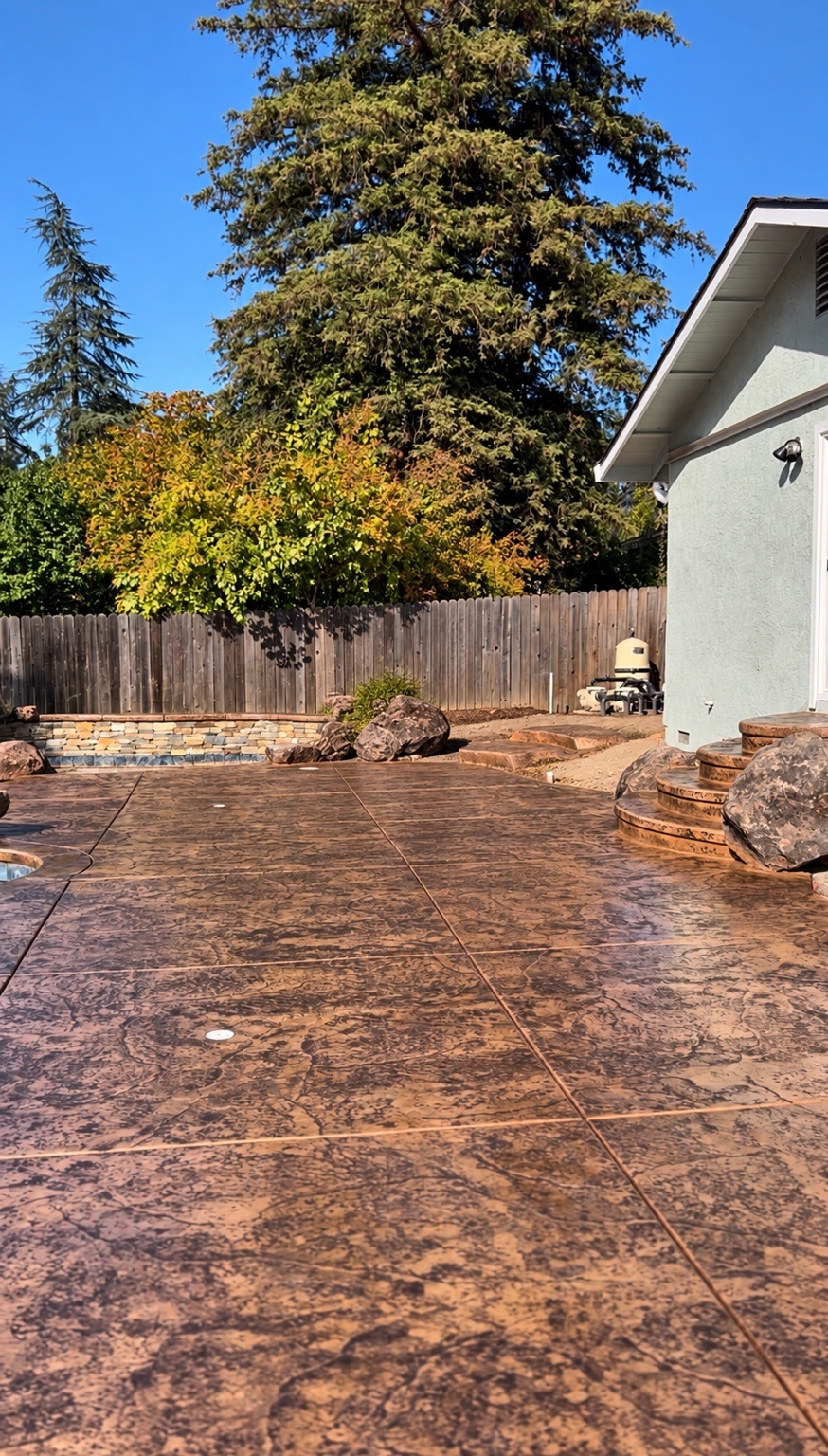 Stamped concrete patio and curved steps
