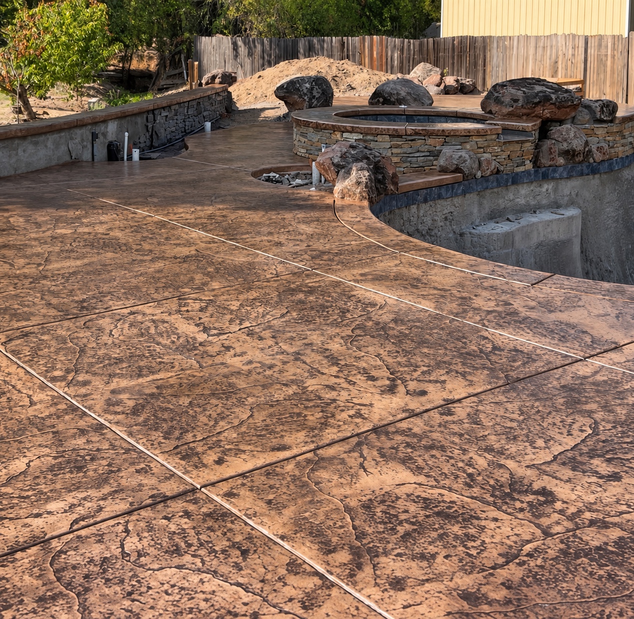 Decorative stamped concrete around a swimming pool
